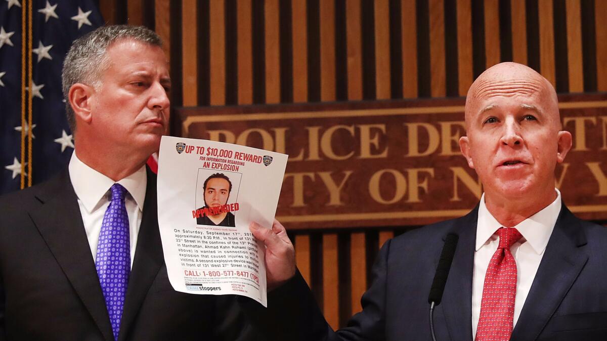 New York City Police Commissioner James O'Neill holds a picture of Ahmad Khan Rahami during a news conference with Mayor Bill de Blasio.