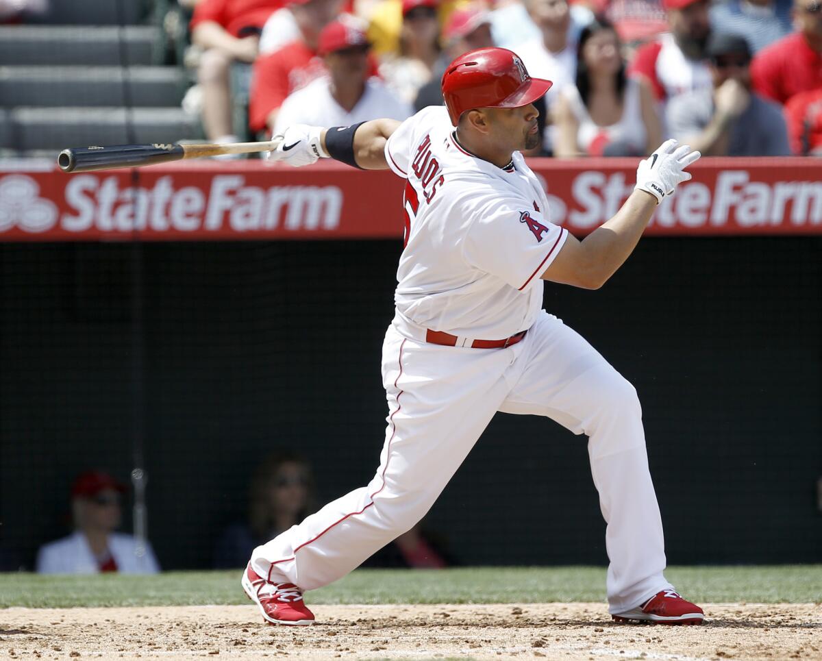 Angels designated hitter Albert Pujols hits an RBI single during the third inning.