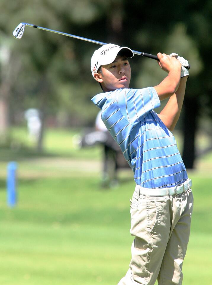 Crescenta Valley's Paul Park hits a fairway shot on the third in a Pacific League boys golf match at Harding Golf Course in Griffith Park in Los Angeles on Thursday, April 24, 2014.