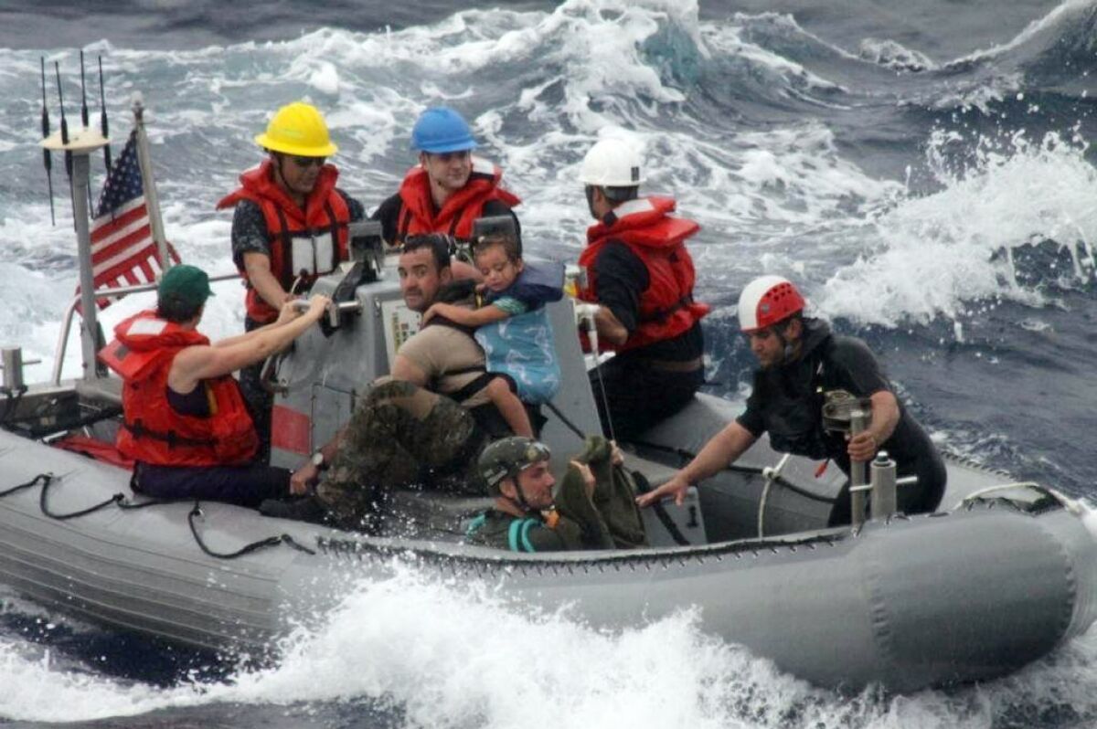 Sailors from the Navy frigate Vandegrift assist in the rescue of the Kaufman family on Sunday.
