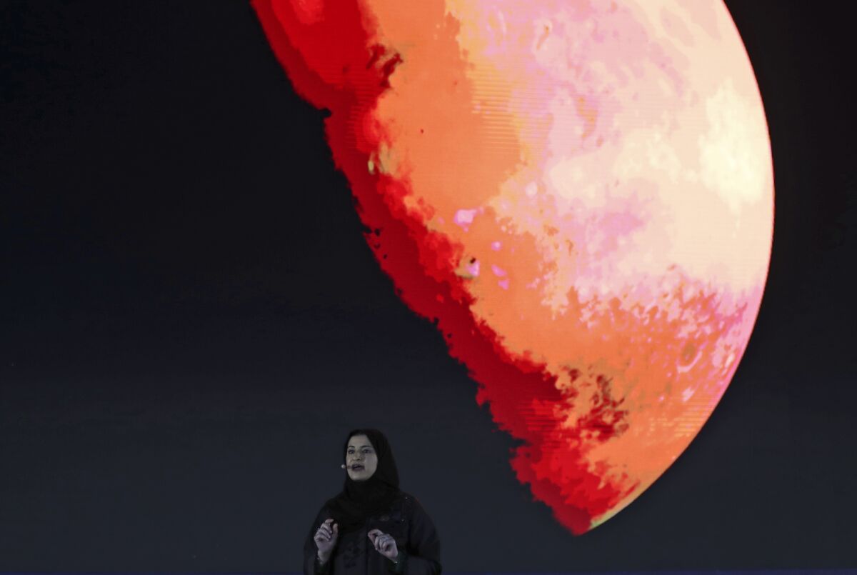 FILE - In this Feb. 9, 2021 file photo, Sarah Al Amiri, Emirati Minister of State for Advanced Sciences and Deputy Project Manager of the Emirates Mars Mission speaks ahead of a live broadcast of the Hope Probe as it attempts to enter Mars orbit as a part of Emirates Mars mission, in Dubai, United Arab Emirates. The United Arab Emirates on Tuesday, Oct. 5, 2021, announced plans to send a probe to land on an asteroid between Mars and Jupiter to collect data on the origins of the universe, the latest project in the oil-rich federation's ambitious space program. (AP Photo/Kamran Jebreili, File)
