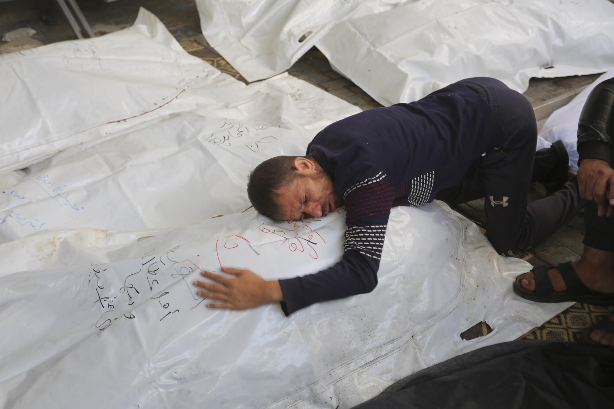Man mourning relatives killed in Israel's bombardment of the Gaza Strip