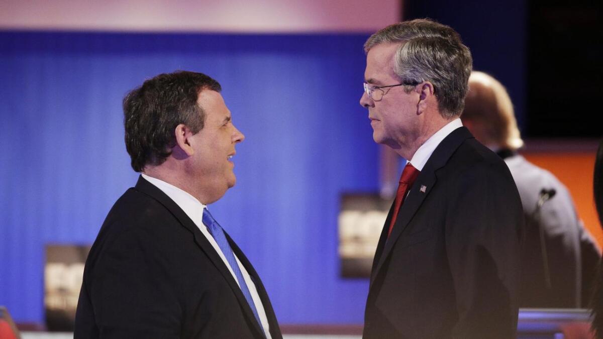 Chris Christie, left, and Jeb Bush during a break in a Republican presidential debate this year.