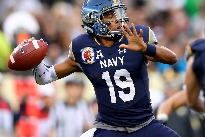Navy quarterback Keenan Reynolds passes the ball in the first quarter against Army.