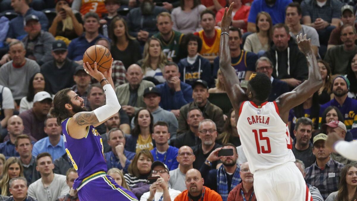 Utah Jazz guard Ricky Rubio (3) shoots as Houston Rockets center Clint Capela (15) defends during the first half.