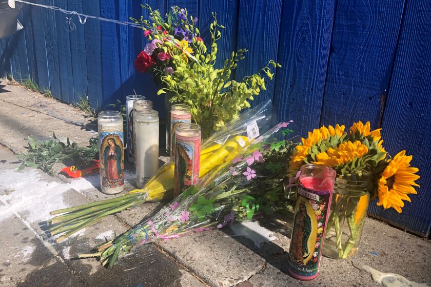 Candles, flowers and balloons were left behind where a 14-year-old boy was fatally shot in City Heights on Sunday afternoon.