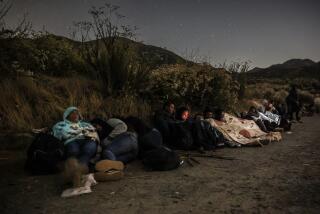 Barrett Junction, CA, Tuesday, June 4, 2024 - Exhausted migrants rest after a 9 plus hours hike over Mt. Cuchoma on a fire road near Campo Rd. after crossing the US/Mexico border in search of asylum. (Robert Gauthier/Los Angeles Times)
