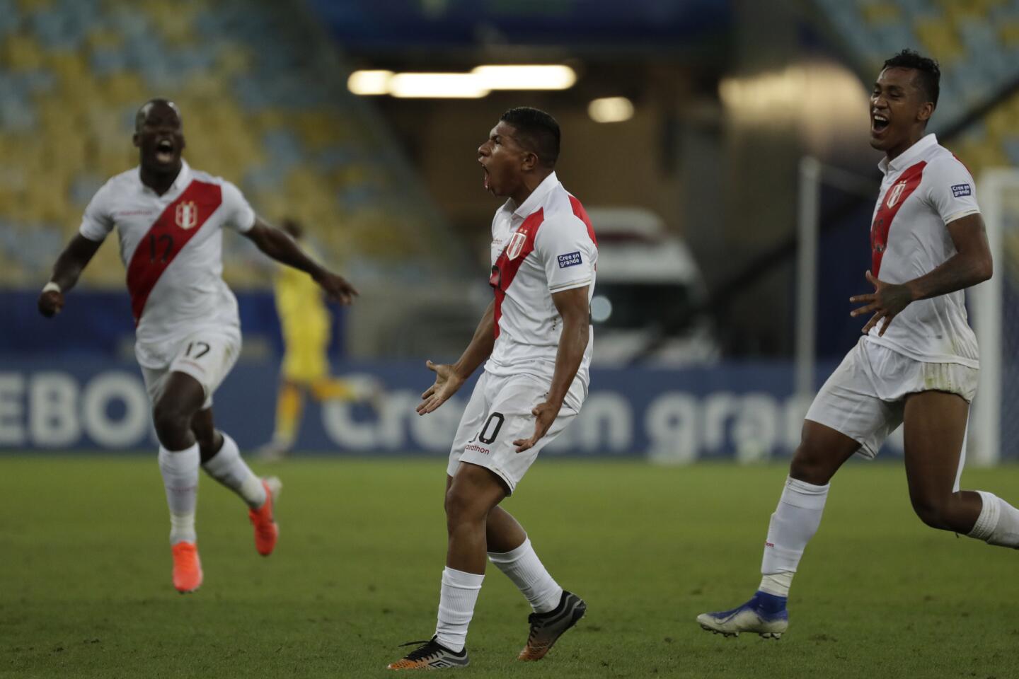 Peru's Edison Flores, center, celebrates scoring his side's 3rd goal against Bolivia during a Copa America Group A soccer match at the Maracana stadium in Rio de Janeiro, Brazil, Tuesday, June 18, 2019.
