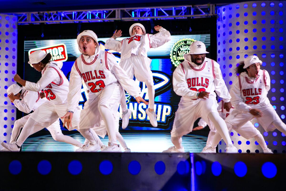 A dance crew in Chicago Bulls jerseys over white shirts and pants.