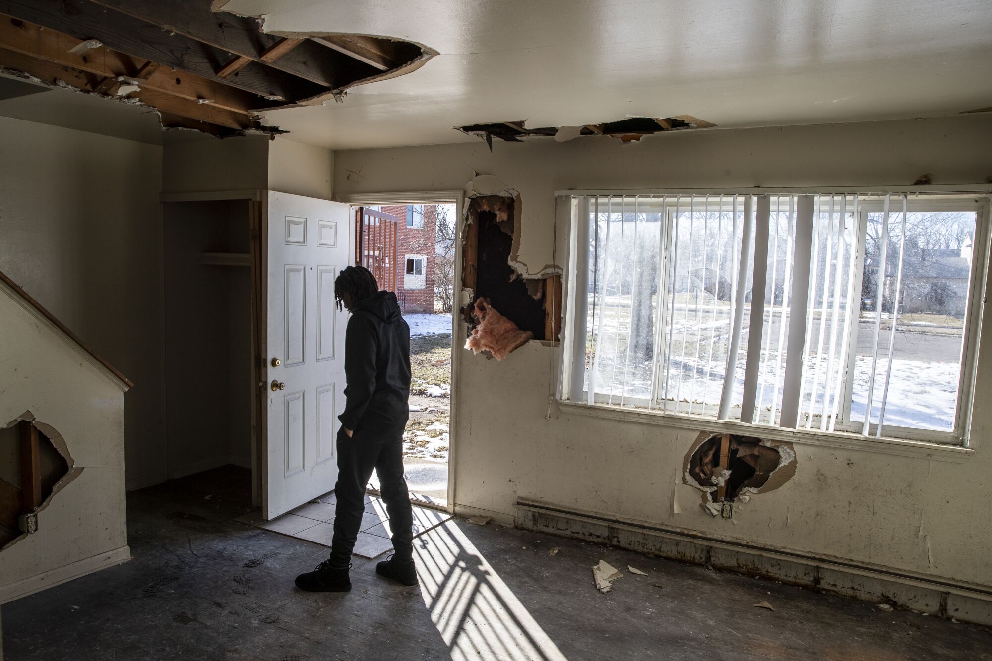 Flint basketball player Onquay Clemons walks into the abandoned, dilapidated remains of his boyhood home.