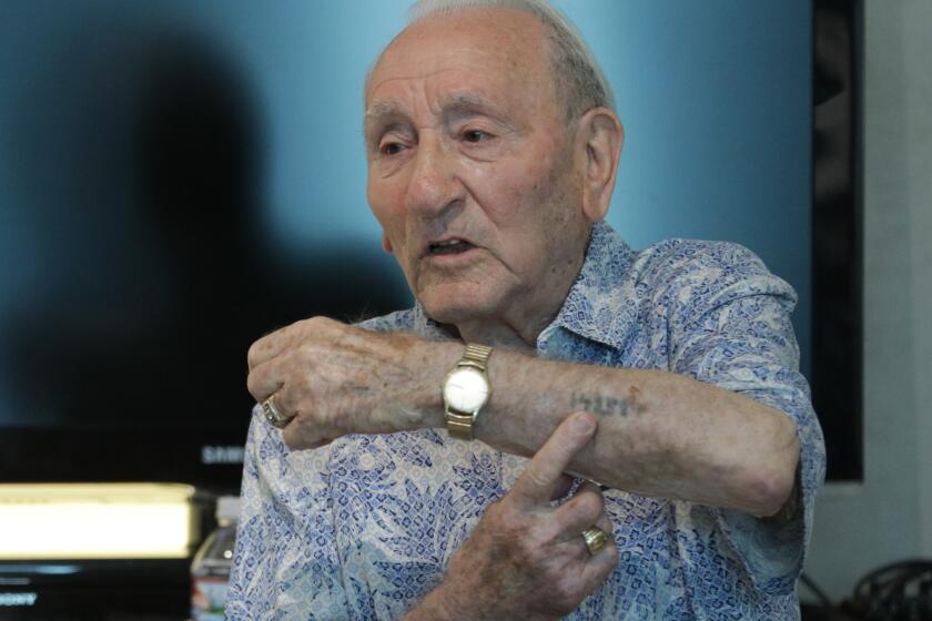 LOS ANGELES, CA -- AUGUST 25, 2019: Joe Alexander, 97, shows his identification tattoo he received at Auschwitz concentration camp. He shared his story of surviving through Auschwitz and Dachau during a talk at the Los Angeles Museum of the Holocaust. (Myung J. Chun / Los Angeles Times)