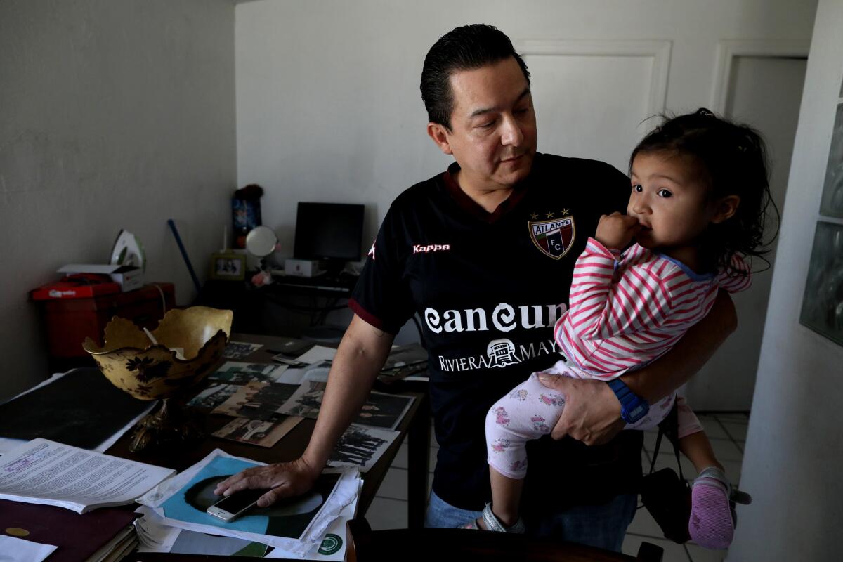 Tijuana police officer Jose Luis Hernandez Galvez, 46, at home with daughter Mia, 19 months. He says he was taken from his home in 2010, accused of stealing and tortured by officers working under Julian Leyzaola, who is now running for mayor of Tijuana.