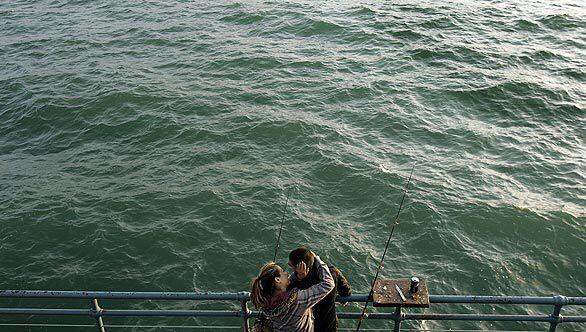 Arturo Devera and Judy Tran take a break from fishing.