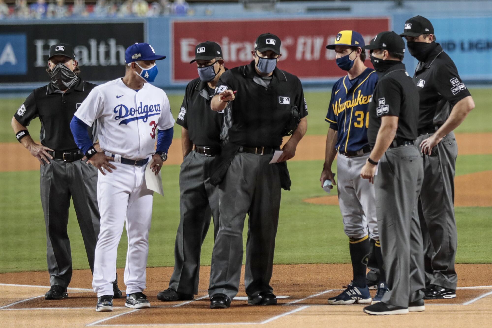 Dodgers manager Dave Roberts and Milwaukee Brewers manager Craig Counsell go over the ground rules.
