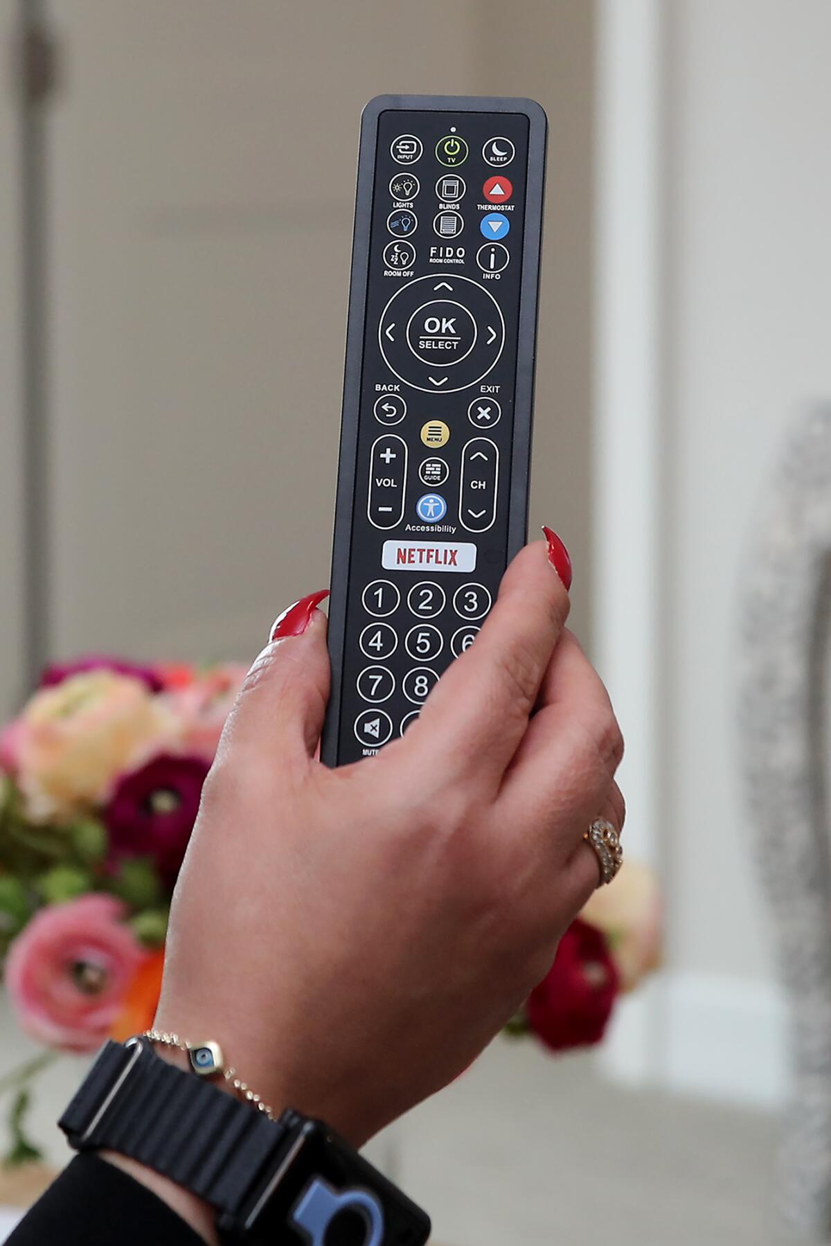 An Enseo remote controller allows access to televisions, window shades, lighting and room temperature.