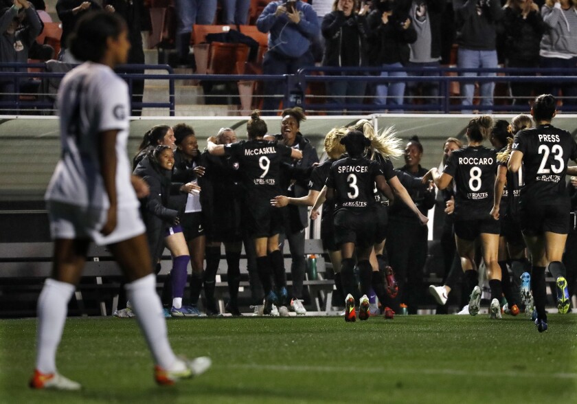 Angel City FC celebrates a goal by Savannah McCaskill against San Diego Wave FC.