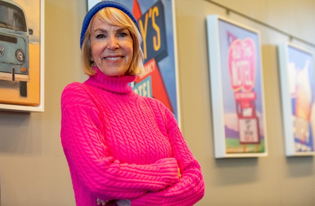 Laguna Beach artist Joan Gladstone stands in front of her pieces at the Newport Beach Library.