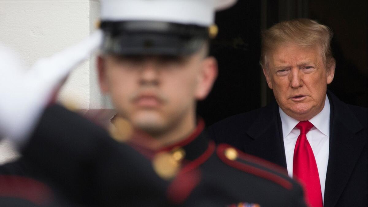 President Donald J. Trump walks out of the South Portico of the White House behind US Marines in Washington on March 25.