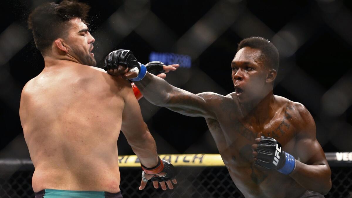 Kelvin Gastelum, left, and Israel Adesanya fight.