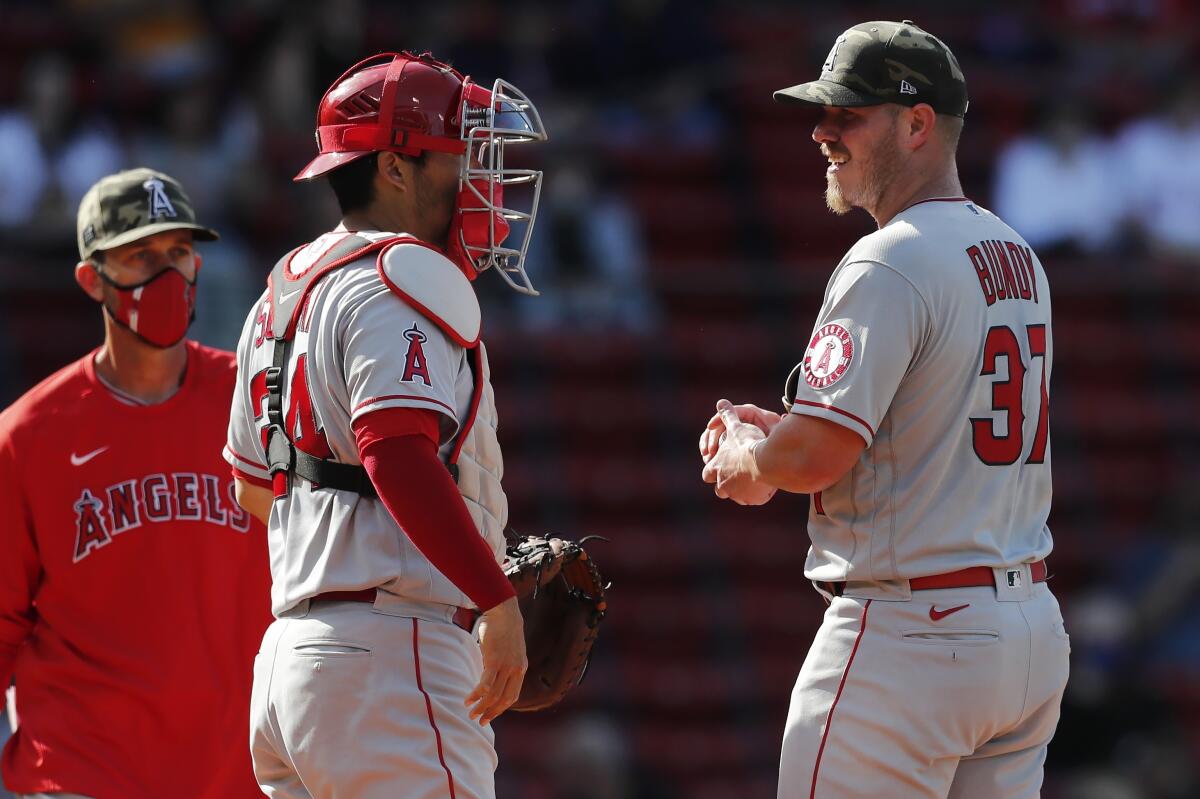 Angels catcher Kurt Suzuki talks with pitcher Dylan Bundy during the first inning May 15, 2021, in Boston.