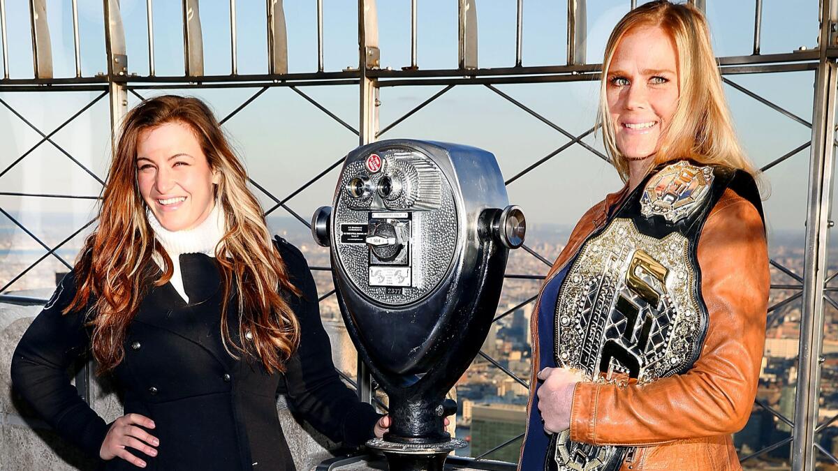 Miesha Tate, left, and Holly Holm visit the Empire State Building during a media event in New York on Jan. 21.