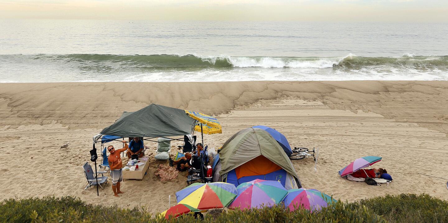 People gather at a collection of tents along Will Rogers State Beach in 2015