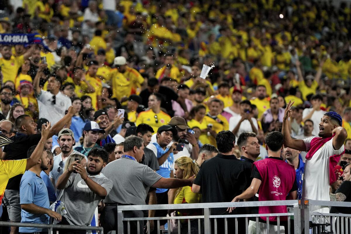 Uruguay's Ronald Araujo, right, argues with fans.