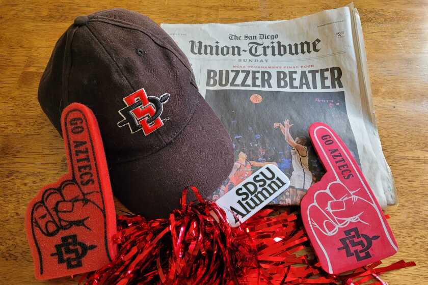 Some of the author's SDSU swag and the U-T edition covering the Aztecs' win in the NCAA Final Four Tournament.