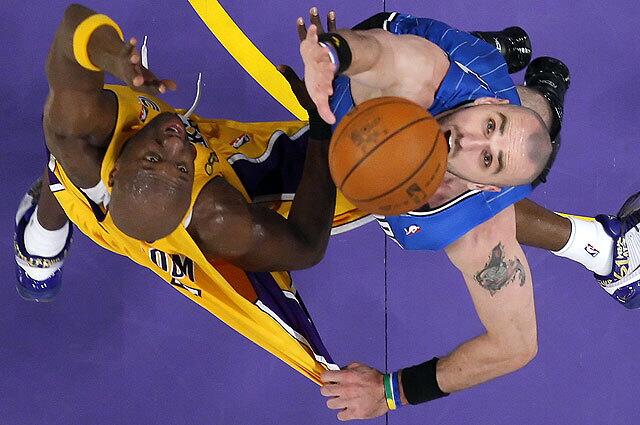 Lakers forward Lamar Odom battles to shoot over Magic defender Marcin Gortat late in Game 1 of the NBA Finals at Staples Center.