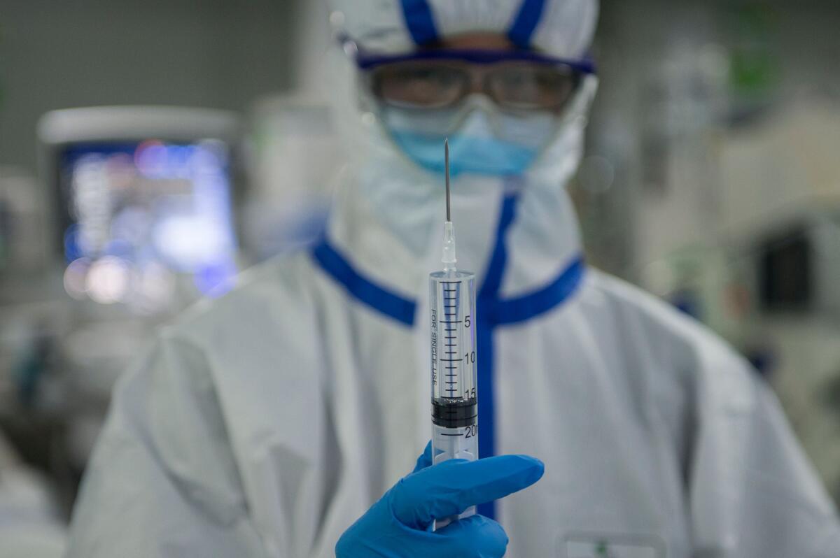 A nurse preparing holds a syringe at a hospital treating coronavirus patients in Wuhan, China, in February.