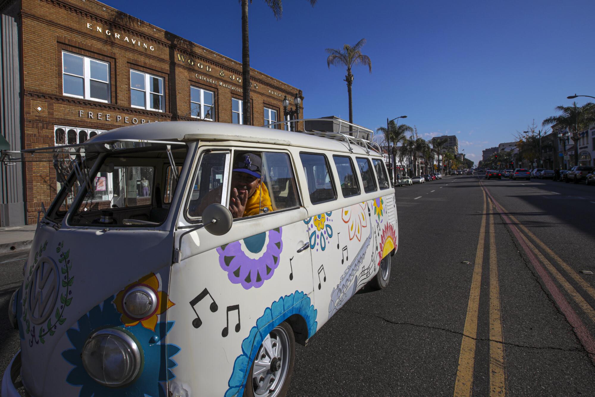 Lalo Alonso, in a 1964 VW bus, cruises on Colorado Boulevard. 