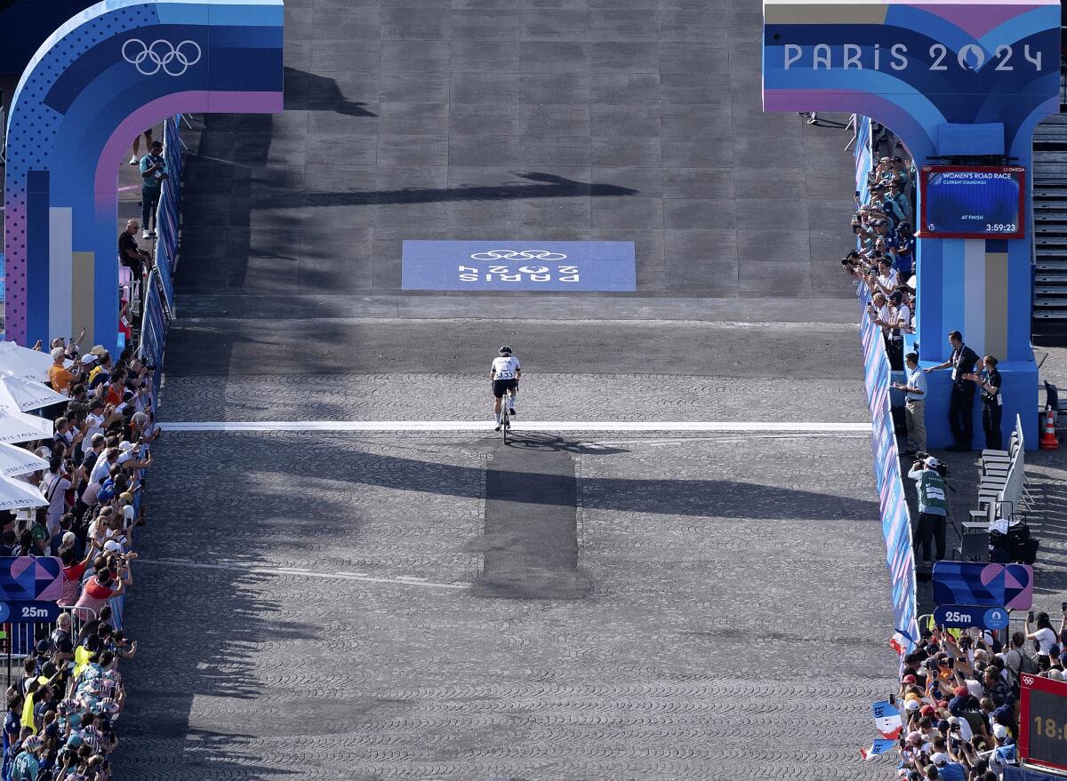 Kristen Faulkner passes the finish line well ahead of the field.