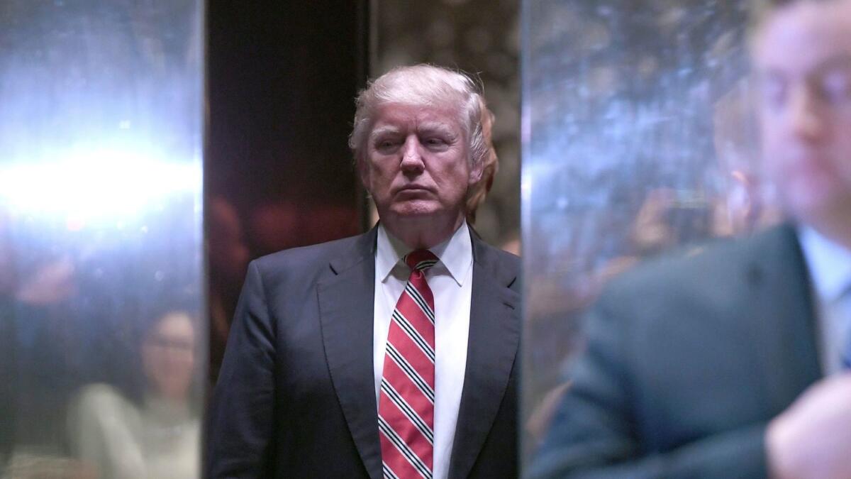 Donald Trump stands inside the lobby elevator after meeting with Martin Luther King III (not pictured) at Trump Tower in New York on January 16.