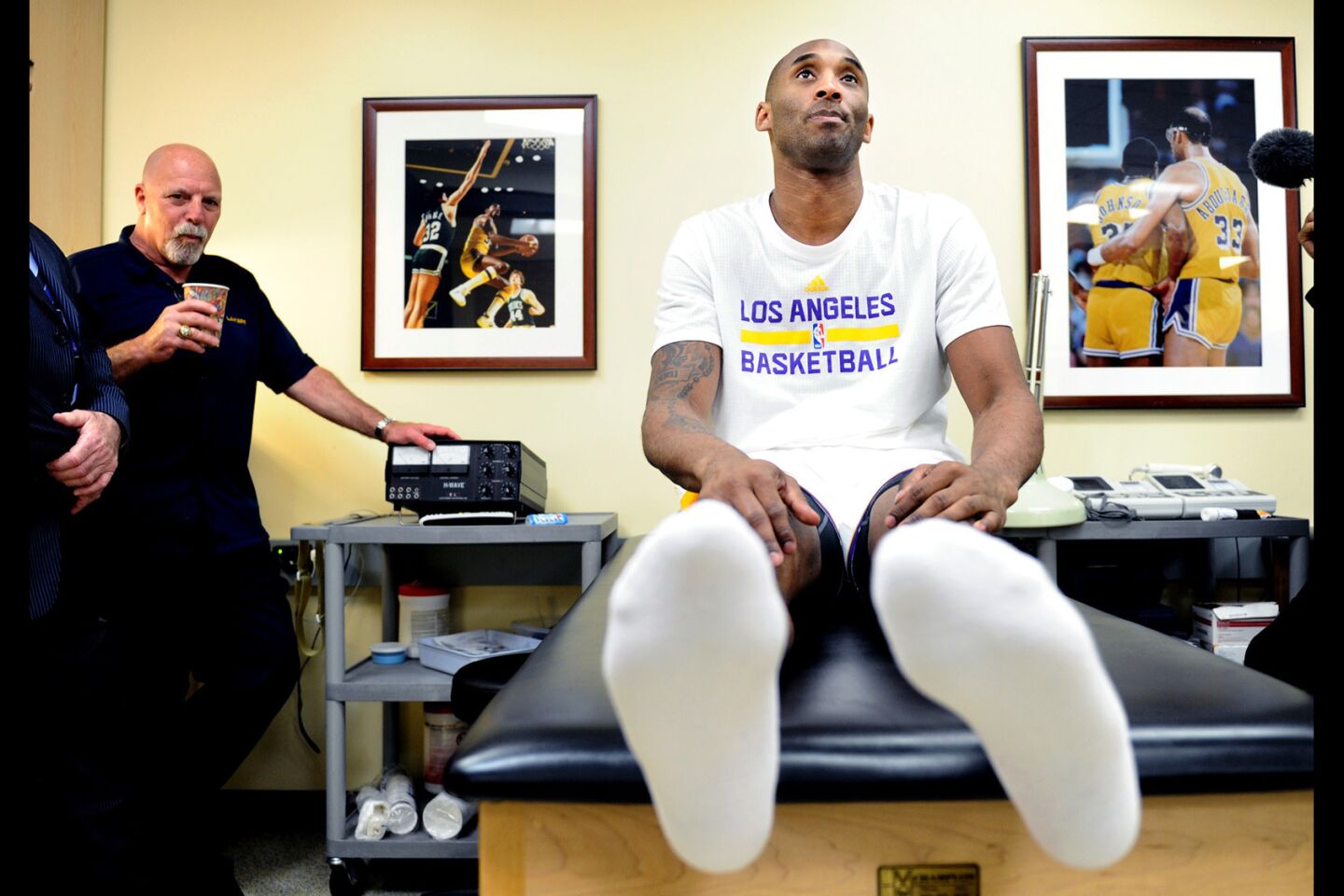 Lakers Kobe Bryant sits on the trainer's table while going through a stretching exercise before a game with the Knicks at the Staples Center.