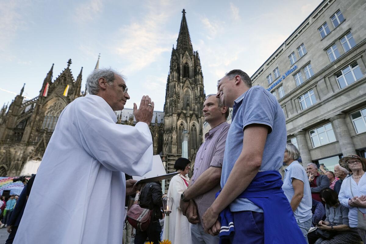 Same-sex couples take part in a public blessing ceremony in front of the Cologne Cathedral in Cologne, Germany.