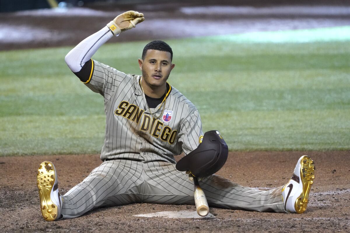 Padres' Manny Machado reacts after almost getting hit with a pitch Sunday in Phoenix.