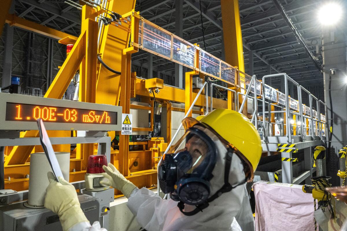 Staff member in protective gear visiting Daiichi nuclear power plant in Fukushima, Jpan