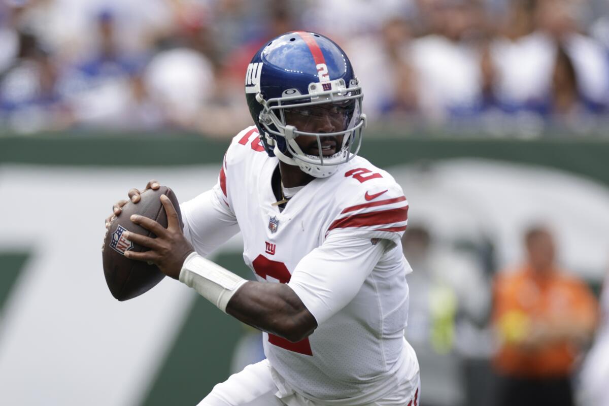 New York Giants quarterback Tyrod Taylor looks to pass in the first half of a preseason game.