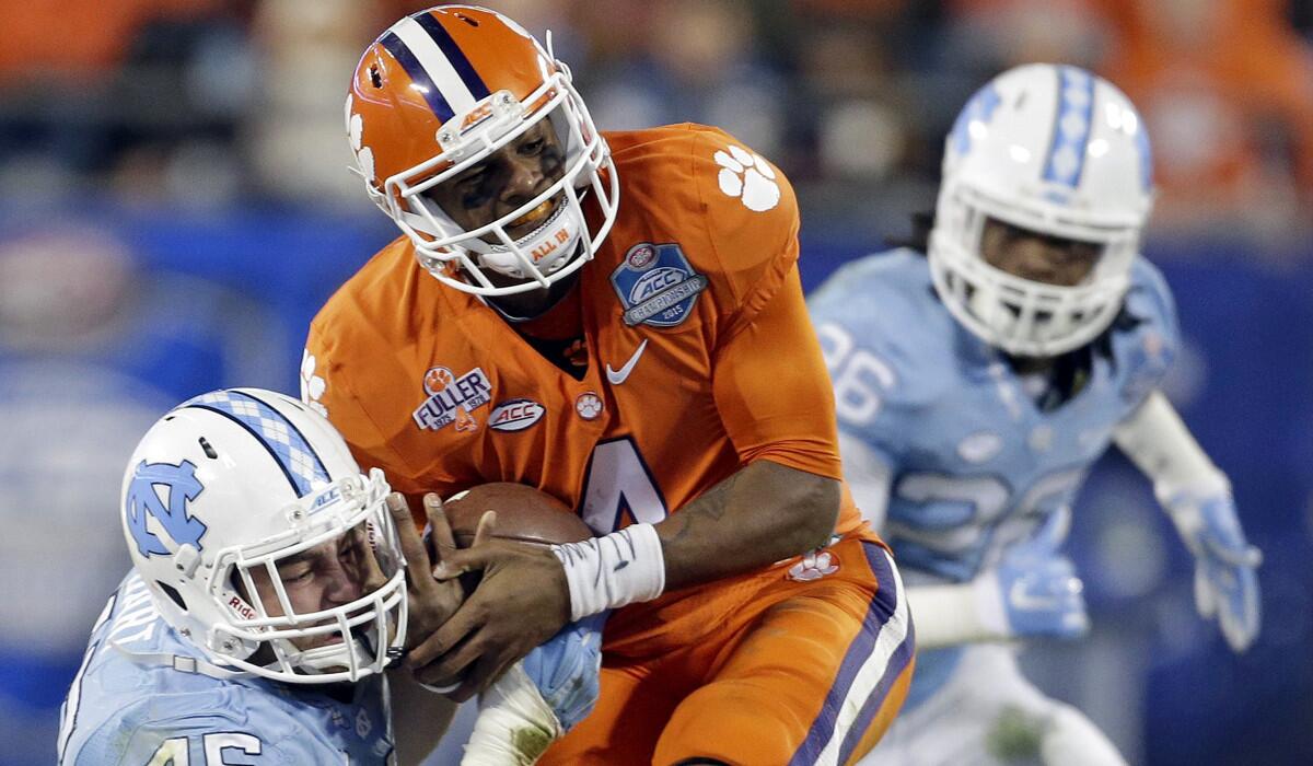 Clemson quarterback Deshaun Watson (4) runs the ball as North Carolina's Mikey Bart (45) tackles during the second half of the Atlantic Coast Conference championship on Saturday.