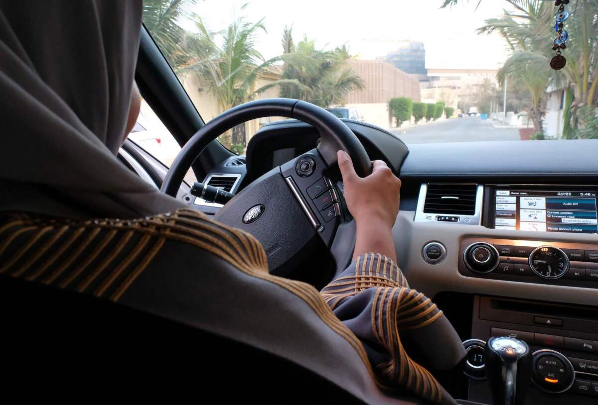 A Saudi Arabian woman drives her car along a street in the coastal city of Jidda