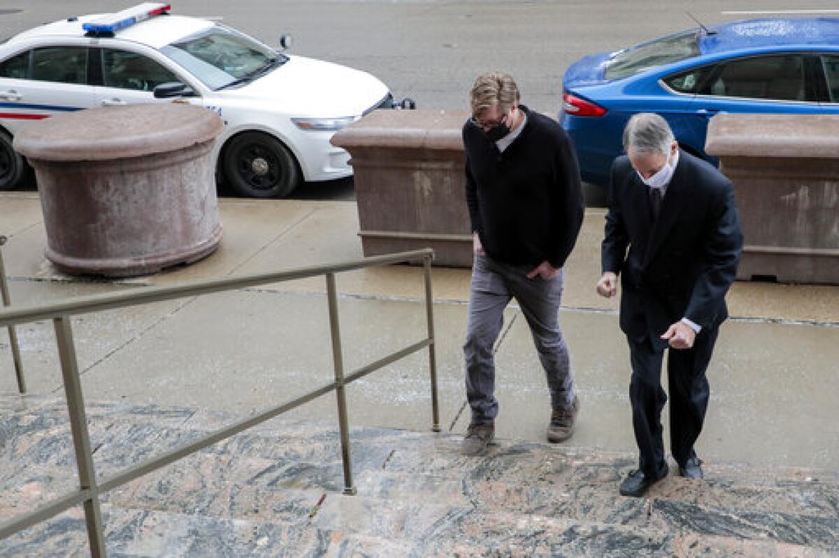 Two men arrive at a courthouse.