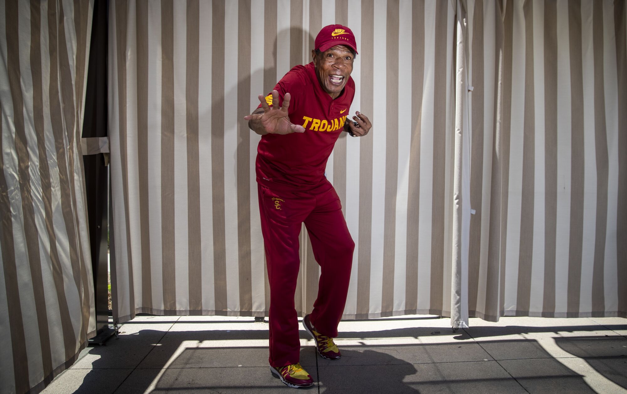 Charles White strikes a Heisman Trophy pose at the memory care facility he now calls home.