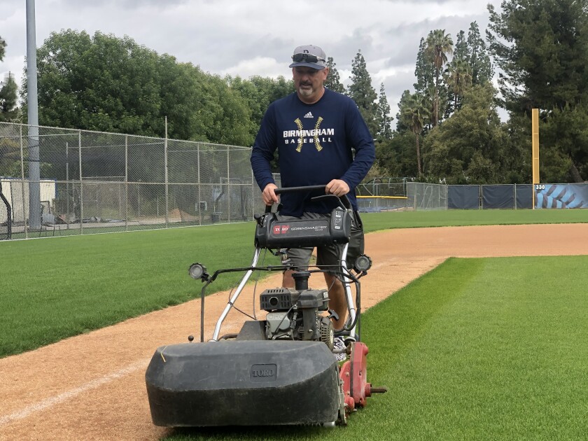 Birmingham baseball coach Matt Mowry has plenty of free time to mow the infield.