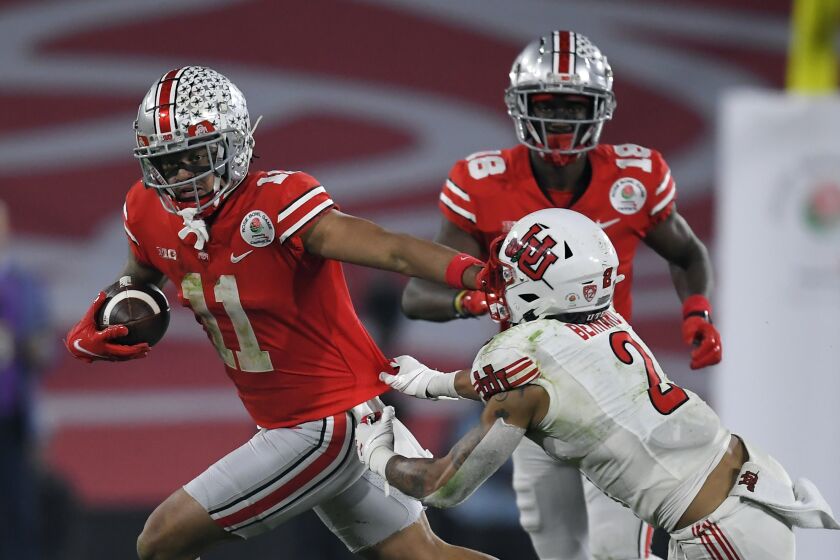 FILE — Ohio State wide receiver Jaxon Smith-Njigba (11) runs past Utah cornerback Kenzel Lawler (2) during the second half in the Rose Bowl NCAA college football game, Jan. 1, 2022, in Pasadena, Calif. Nine months later, the sting of losing to Michigan is still fresh for Ohio State. “It was sickening,” Ohio State receiver Jaxon Smith-Njigba said of the 42-27 thumping Nov. 27 in Ann Arbor that ended an eight-game Buckeyes winning streak in the rivalry game. (AP Photo/John McCoy, File)