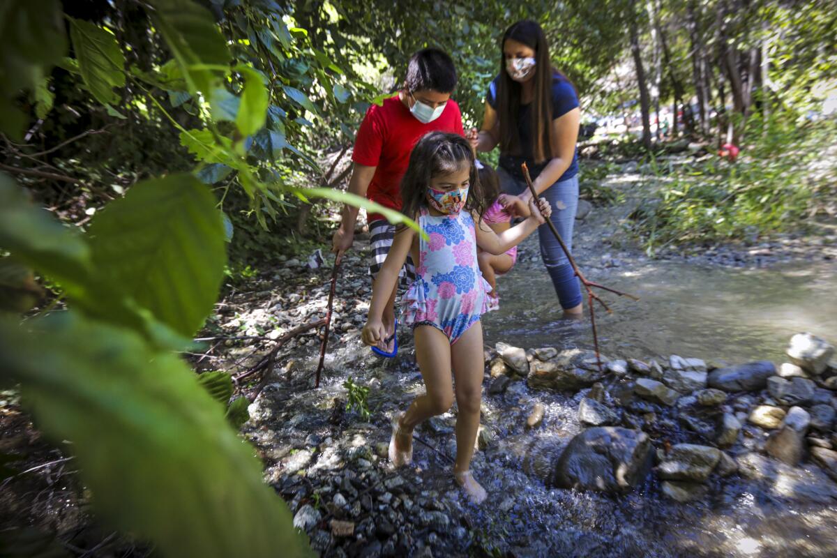 Youngsters walk along a stream at Lytle Creek in San Bernardino County on a summer afternoon.