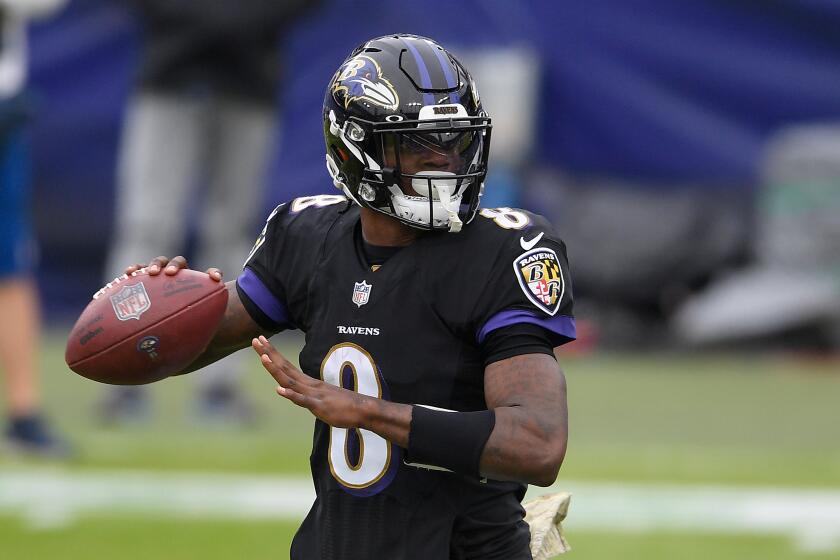 Baltimore Ravens quarterback Lamar Jackson (8) in action during the first half of an NFL football game.