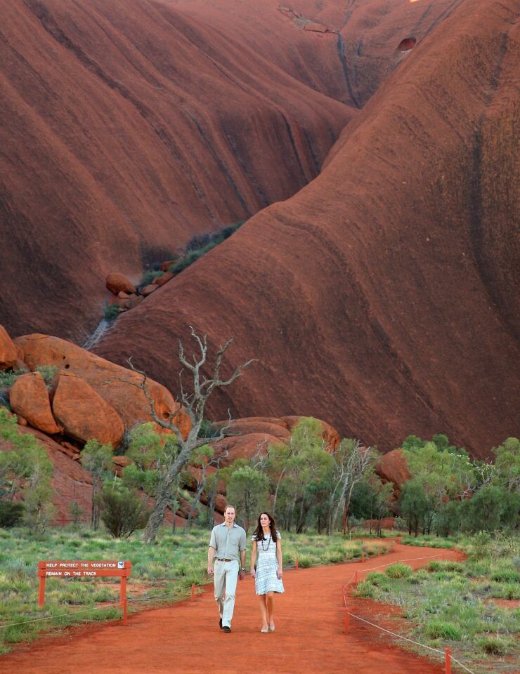 The second in line to the British throne walks with his wife down Kuniya Walk at the base of Uluru in Ayers Rock.