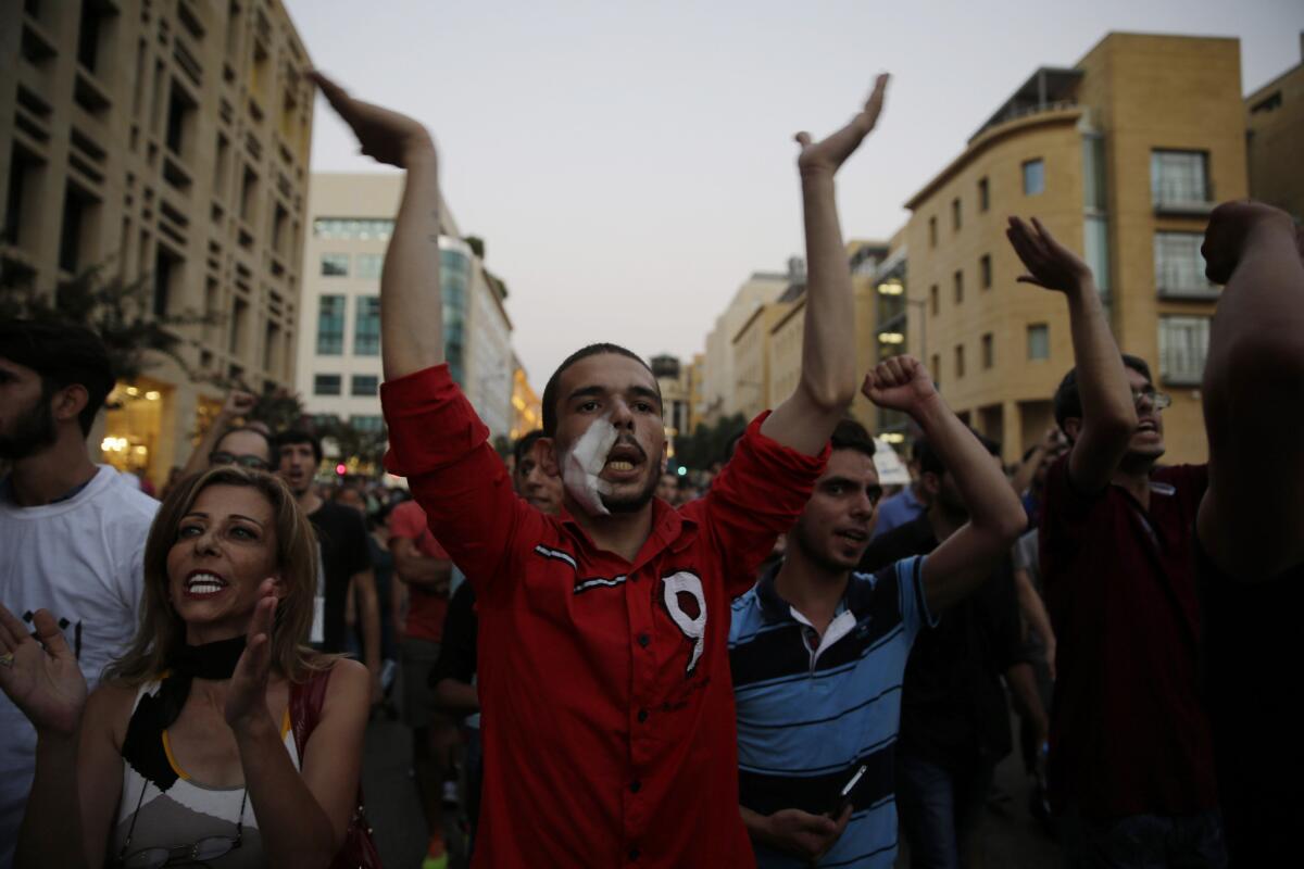 Lebanese activists chant slogans during a protest over uncollected trash and government ineptitude in downtown Beirut, on Aug. 26, 2015.