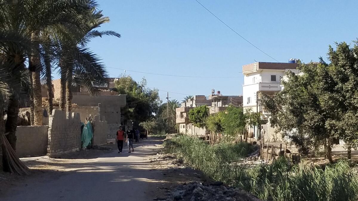Boys walk to school in Rashid, where some families and friends encourage youths to migrate to Italy. Those who survive the dangerous journey send money home to build houses.