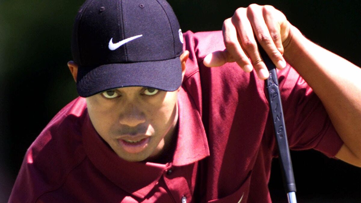 Tiger Woods lines up a putt in 2001